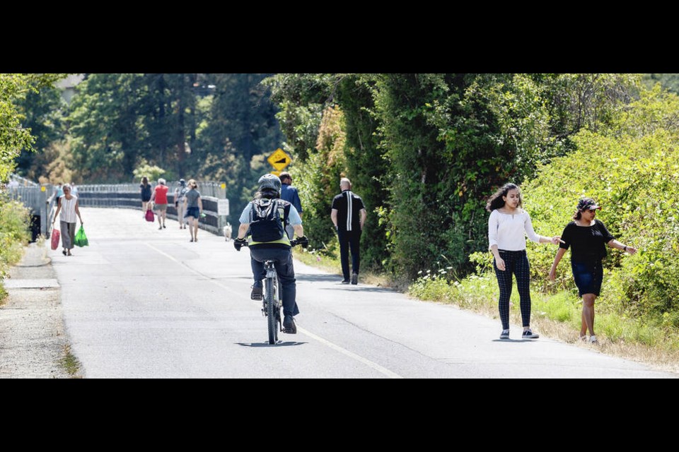 Cyclists and pedestrians share the busy Galloping Goose Regional Trail at the north end of the Selkirk Trestle. Plans are afoot to widen the trail. DARREN STONE, TIMES COLONIST 