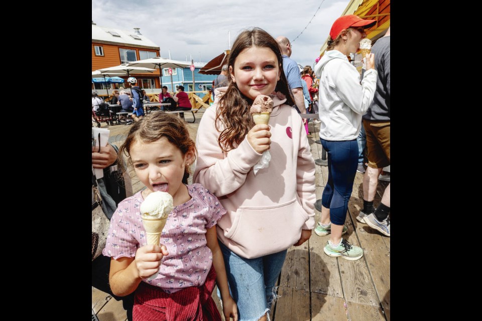 Nora Conley, 6, and Ella Conley, 10, with vanilla, left, and chocolate ice-cream cones at Fisherman’s Wharf. DARREN STONE, TIMES COLONIST 