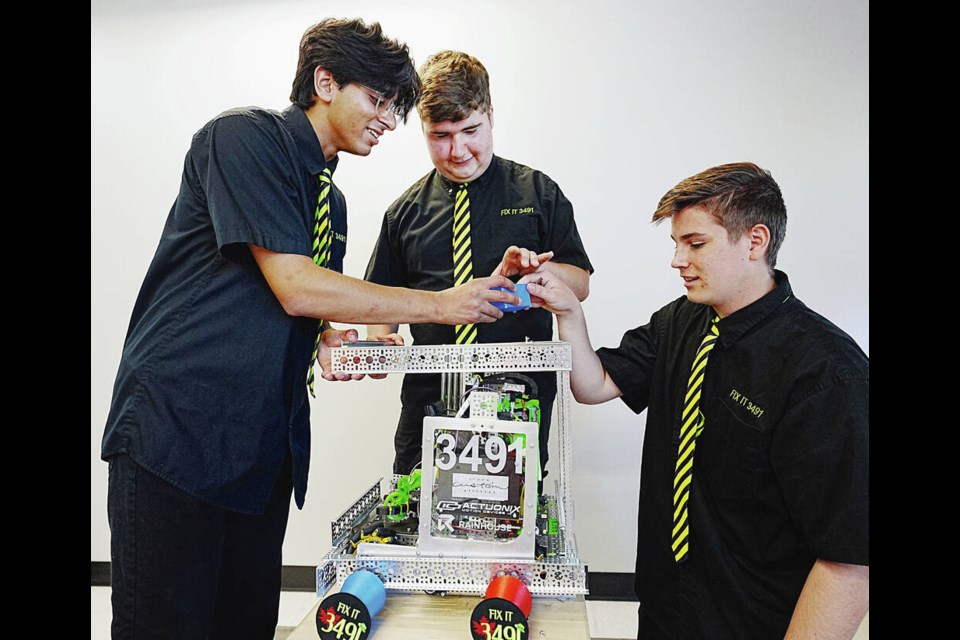 From left, Amren Kareer, Garrett Waddell and Max Gregg pack up their robot at Vancouver Island Technology Park Thursday before leaving for Sydney, Australia for the Asia-Pacific Championships at Macquarie University in Sydney, Australia. ADRIAN LAM, TIMES COLONIST  