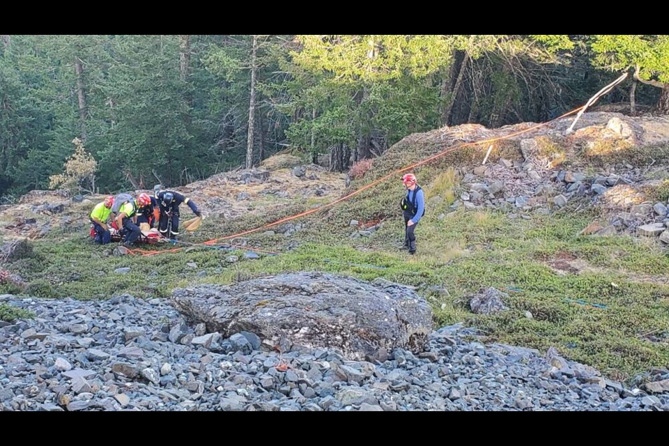 First responders tend to a hang glider who crashed into a tree on Salt Spring Island on Monday, Aug. 7, 2023. SALT SPRING ISLAND SEARCH AND RESCUE