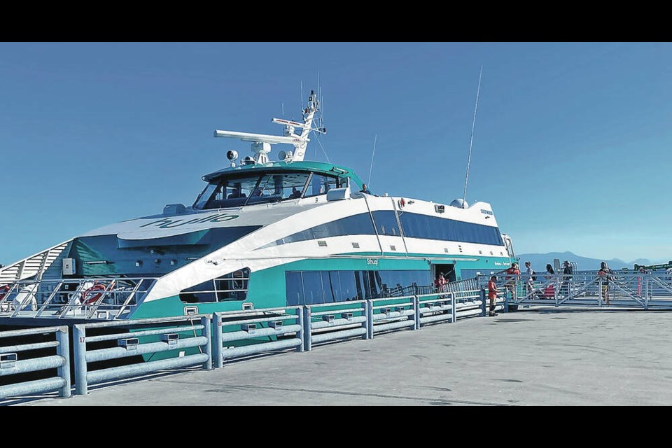 Passengers line up to board the first sailing of the new Hullo ferry that left Wednesday morning. 
TIMES COLONIST 