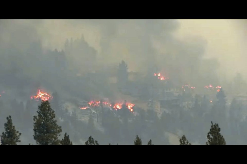 Multiple houses burn in the MacDougall Creek wildfire in the Kelowna area on Friday.    VIA CASTANET VIDEO