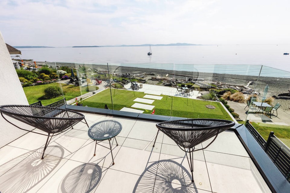 Metal chairs cast cool shadows on the patio off the master bedroom. DARREN STONE, TIMES COLONIST 