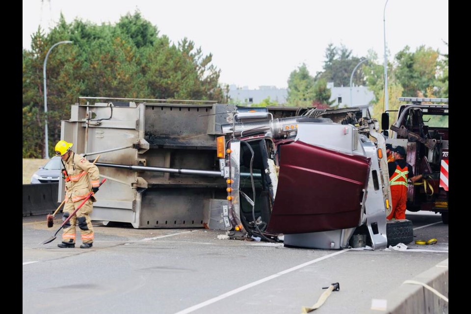 A commercial vehicle crashed and flipped onto its side on the Patricia Bay Highway in Saanich on Wednesday. DARREN STONE, TIMES COLONIST 