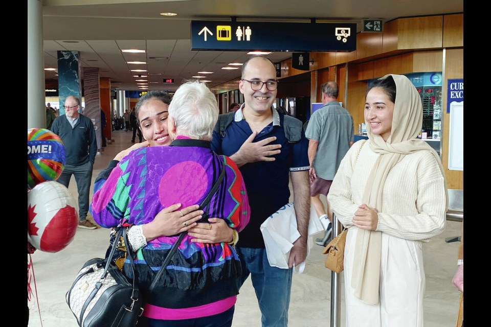 Khadijah Akakhail hugs Patricia Houston, who spearheaded efforts to sponsor her family to settle in ­Victoria, after Akakhail landed in Victoria, while Hamed Tasal and Tahmina Akakhil enjoy the reunion. Story, A4. TIMES COLONIST 
