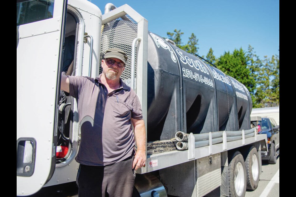 Driver Glenn Horton, waiting in line on Galiano Island for a return trip to Vancouver Island, works for South Island Water, which makes deliveries to the Gulf Islands almost six days a week during summer months.  via VANCOUVER SUN
