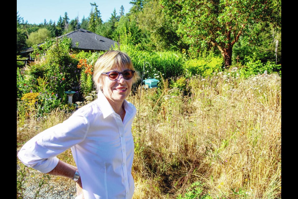 Galiano resident Jennifer Margison in front of her home among natural, drought-resistant landscaping.   via VANCOUVER SUN