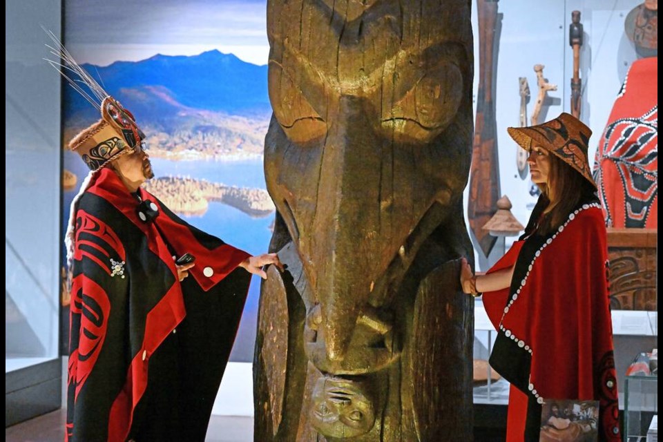 Amy Parent, right, is shown with the Ni'isjoohl memorial pole alongside Nisga'a Chief Earl Stephens during a visit to the National Museum of Scotland in a handout photo. A homecoming celebration for a memorial totem pole after an absence of almost 100 years will resonate far beyond the tiny Indigenous village in northwest British Columbia to which it returns on Friday. THE CANADIAN PRESS/HO-National Museums Scotland-Neil Hanna **MANDATORY CREDIT**