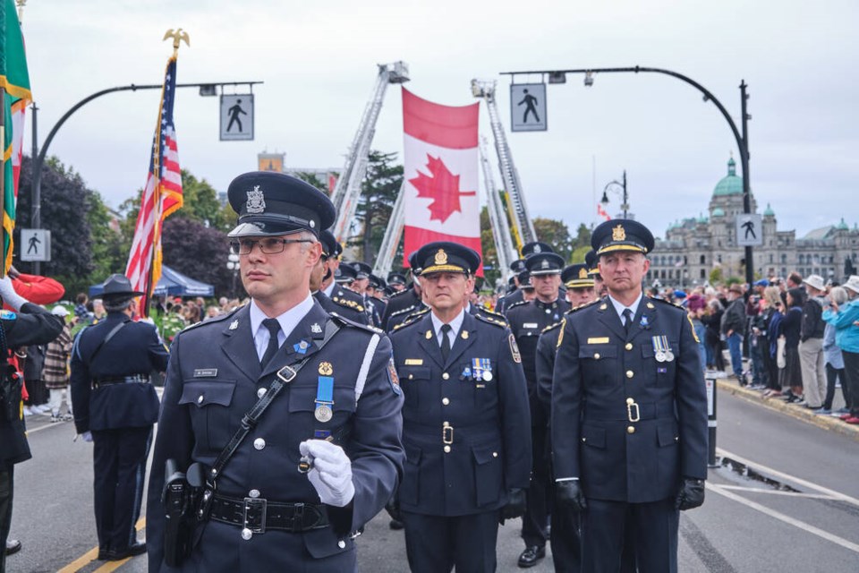 From left, Const. Mikhail Smirnov of Saanich police, Oak Bay Police Chief Mark Fisher and Saanich Police Chief Dean Duthie stand at attention for the B.C. Law Enforcement Memorial Service parade on Sunday, Sept. 24, 2023. TIMES COLONIST 