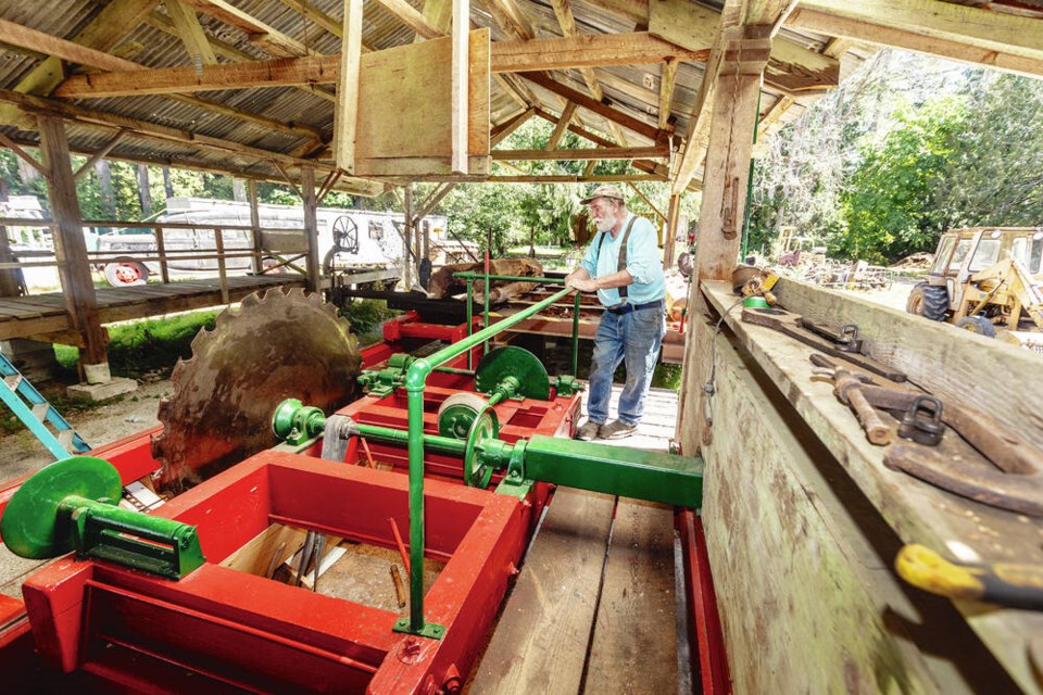 David Hopkins, vice-president of the Saanich Historical Artifacts Society, with a 1910 American Saw Mill Machine found near Youbou that is being restored. DARREN STONE, TIMES COLONIST 