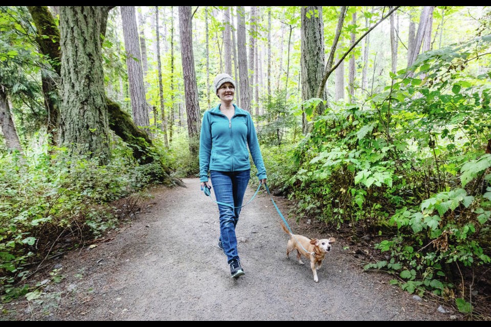 Lisa Nott walks her dog Rosco in Mount Douglas Park this week. Saanich is proposing restricting off-leash dogs to designated park areas. DARREN STONE, TIMES COLONIST 