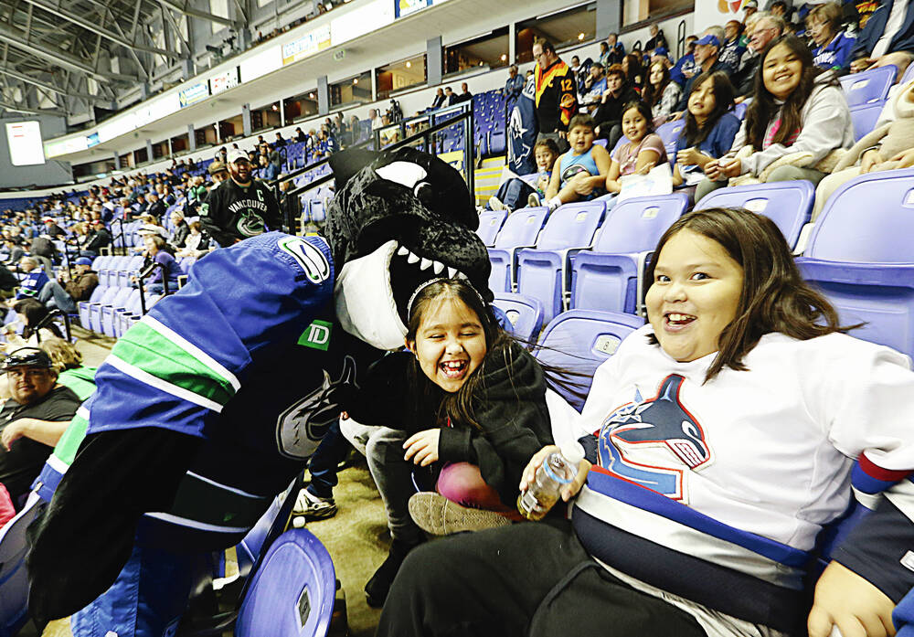 Vancouver Canucks mascot Fin entertains fans with his t-shirt gun