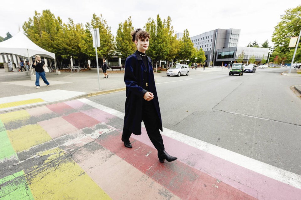 Cleo Philp, director of campaigns and community relations with the University of Victoria Students’ Society, uses the Rainbow Crosswalk at UVic. It was first painted in 2015 and is fading. DARREN STONE, TIMES COLONIST  