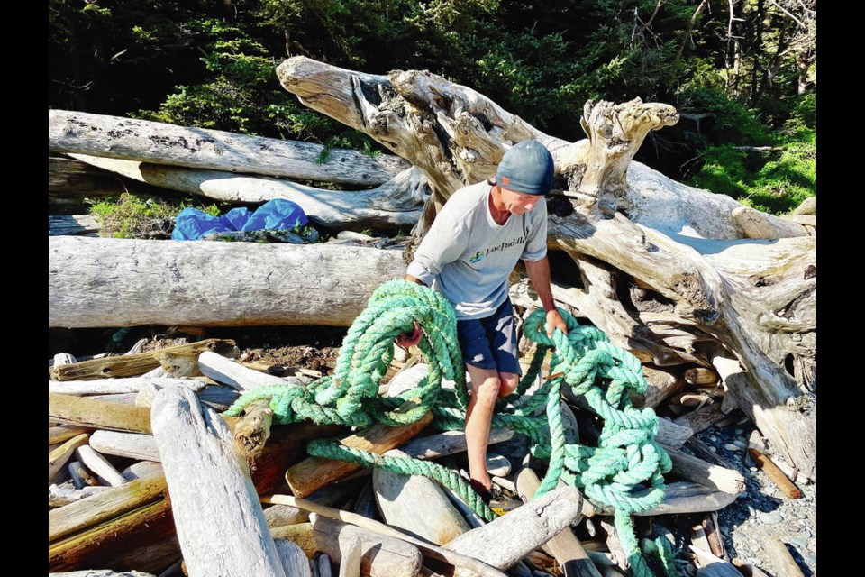 David Jensen with debris he collected from a remote beach on northern Vancouver Island. The outdoor enthusiast and adventurer uses his paddleboard to reach beaches and coves inaccessible to boats. VIA LIVING OCEANS 
