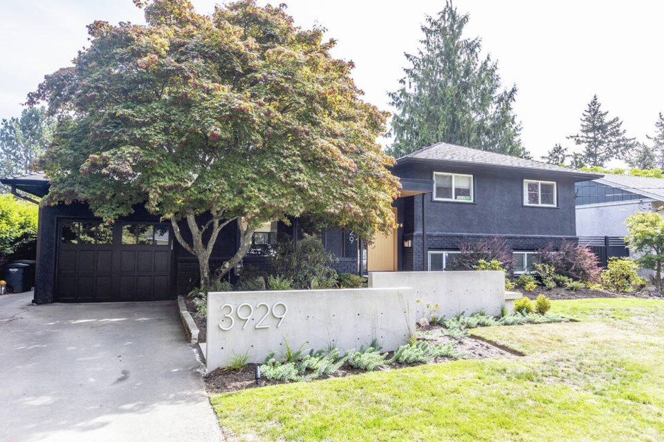 The 1955 house was painted beige when the homeowners bought it but they updated the look by painting it black and adding modern house numbers. DARREN STONE, TIMES COLONIST 