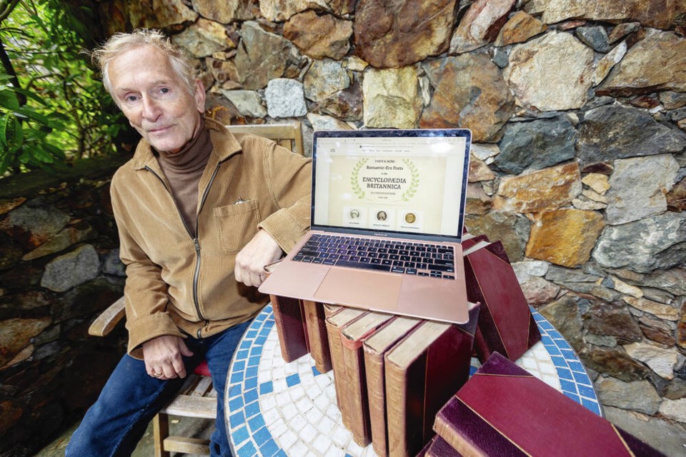 Kim Blank with the 1910-1911 Encyclopedia ­Britannica set he found in a recycling bin  at the ­University of ­Victoria.  DARREN STONE, TIMES COLONIST 