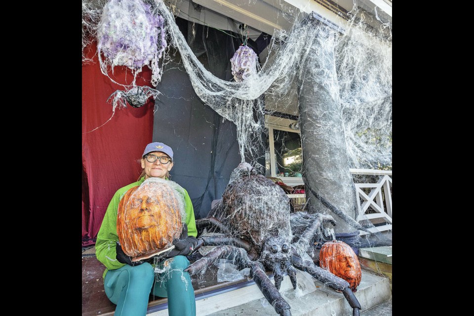 Tara Norris holds a pumpkin with a casting of her face in it -- part of her Halloween display at 528 St. Charles St. There are plenty of spooky Halloween decorations around, but some ­Greater Victoria homeowners are taking their outdoor displays to the next level. DARREN STONE, TIMES COLONIST 