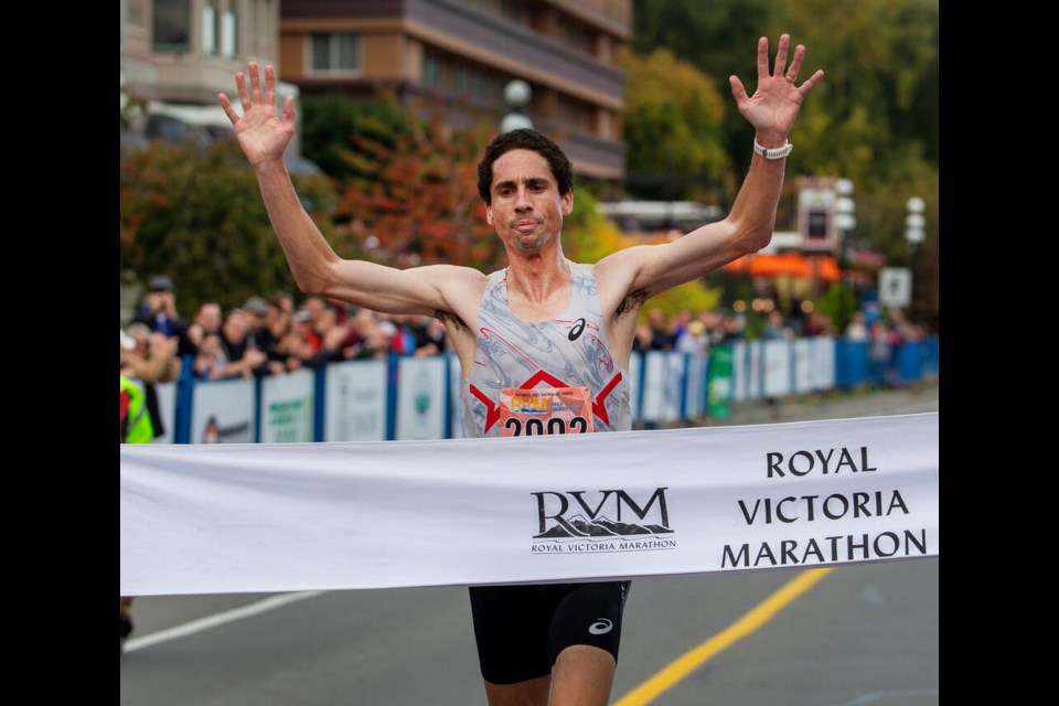 Royal Victoria Half Marathon winner Cam Levins crosses the finish line on Belleville Street on Sunday. DARREN STONE, TIMES COLONIST 