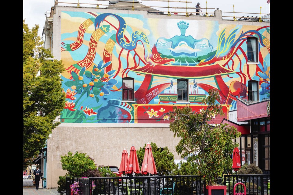 A new mural on a building that houses Canada’s oldest Chinese temple depicts embroideries and banners that were damaged in a 1980 building fire.  DARREN STONE, TIMES COLONIST