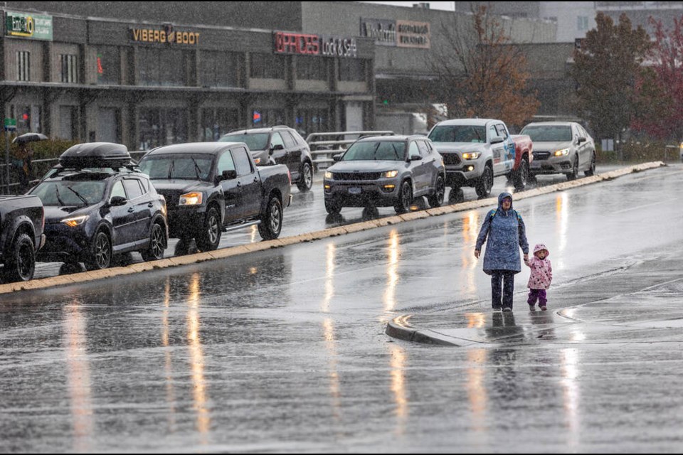 Pedestrians walk in a downpour on Harriet Road near Uptown in Saanich on Monday, Oct. 16, 2023. DARREN STONE, TIMES COLONIST 