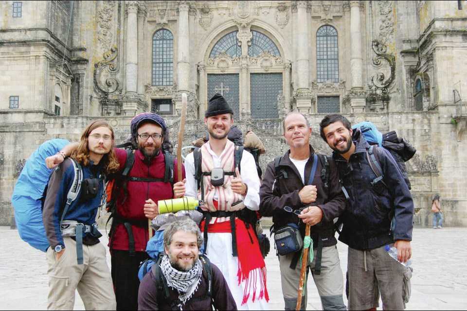 Happy hikers celebrate the end of their 800-kilometre pilgrimage in front of the Cathedral of St. James in Santiago, Spain. RICK STEVES 