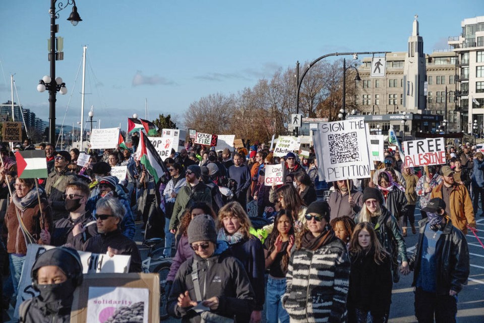 Protesters march down Government Street on Sunday in a rally callying for a ceasefire in Gaza. TIMES COLONIST 