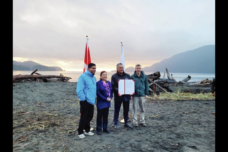 Gary Anandasangaree, minister of Crown-Indigenous relations; Ditidaht Chief Councillor Judi Thomas; Pacheedaht Chief Councillor Jeff Jones; and Dave Tovell, Acting Field Unit Superintendent, Coastal B.C., mark an agreement to return the use of ?A:?b?e:?s (Middle Beach) to the Pacheedaht First Nation near Port Renfrew on Wednesday, Nov. 15, 2023. PARKS CANADA 