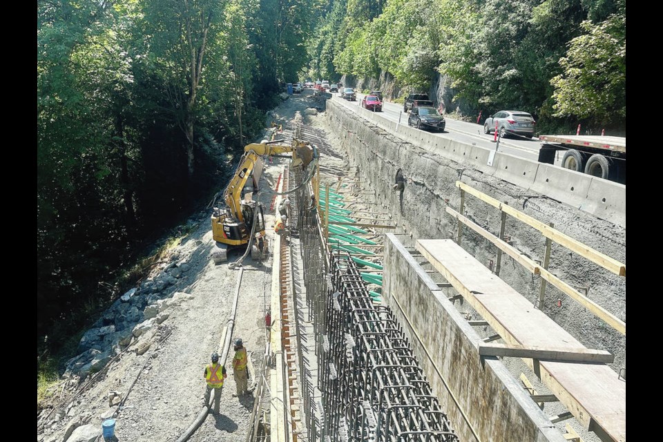 Each of 84 rebar-enforced piles was secured to bedrock using corrosion-protected anchors to provide horizontal stability to a new 100-metre-long retaining wall that now supports the Malahat highway between the cliff and slope. MINISTRY OF TRANSPORTATION AND INFRASTRUCTURE 