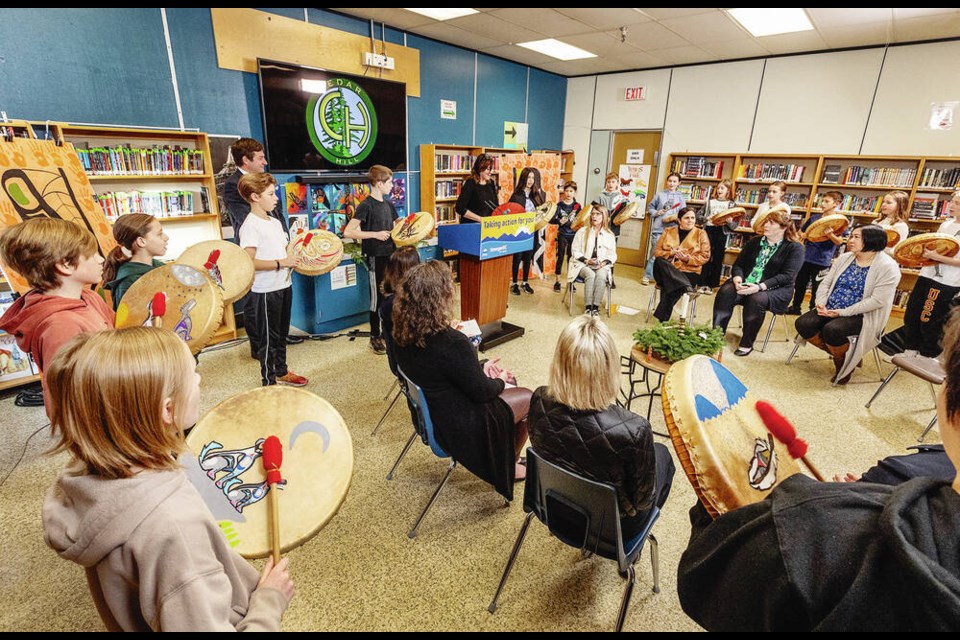 Grade 6 students drum during a ceremony in the Cedar Hill Middle School library on Monday to mark the start of construction of a new school. DARREN STONE, TIMES COLONIST 