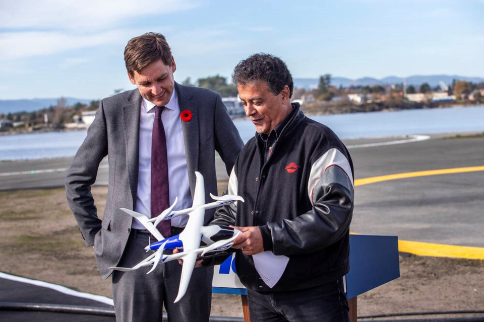 B.C. Premier David Eby, left, and Helijet president and CEO Danny Sitnam look at a model of the electric vertical takeoff ALIA eVTOL aircraft from BETA Technologies at a press conference at the Victoria Heliport on Tuesday, Oct. 31, 2023. DARREN STONE, TIMES COLONIST 