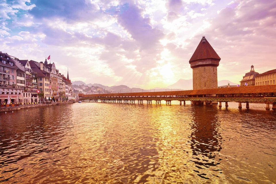Luzern’s Reuss River is spanned by the wooden Chapel Bridge, with its iconic stone water tower.  DOMINIC ARIZONA BONUCCELLI 