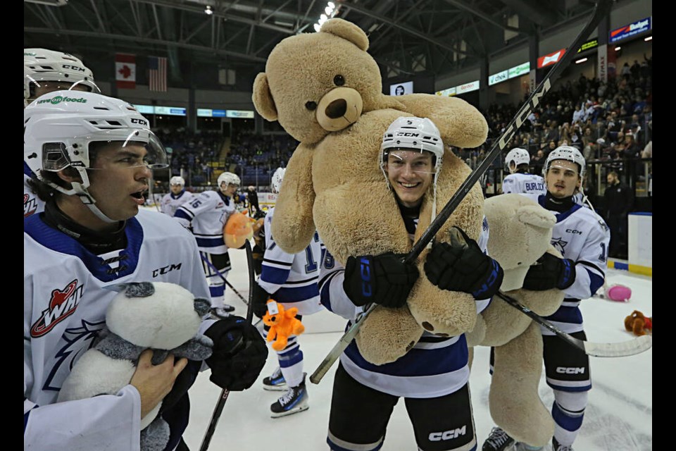 Victoria Royals’ Austin Zemlak with a teddy bear at Victoria Royals’ Teddy Bear Toss night at Save on Foods Memorial Centre on Saturday. The teddy bears tossed by fans will be donated to local charities. ADRIAN LAM, TIMES COLONIST 