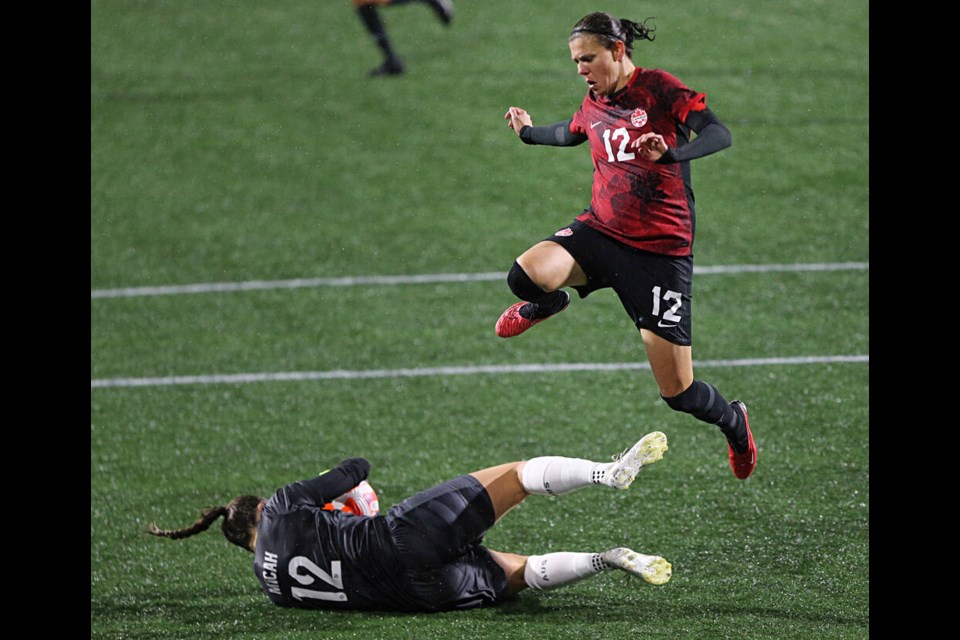 Team Canada striker Christine Sinclair leaps over Australia goalkeeper Tegan Micah during second-half action at Starlight Stadium on Friday, Dec. 1, 2023. ADRIAN LAM, TIMES COLONIST