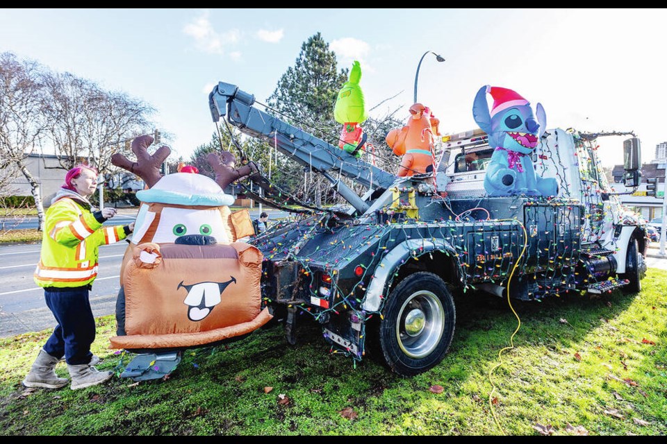 Kaitlyn Parker gets the All-Ways Towing truck ready for the the IEOA Lighted Truck parade on Saturday. DARREN STONE, TIMES COLONIST 