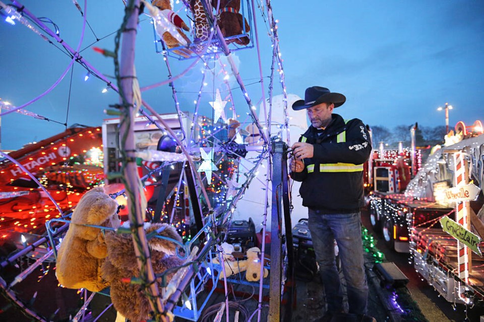 Rob Galey puts the final touches on his truck before the start of the Island Equipment Owners' Association's annual Lighted Truck Parade on Saturday, Dec. 2, 2023. ADRIAN LAM, TIMES COLONIST