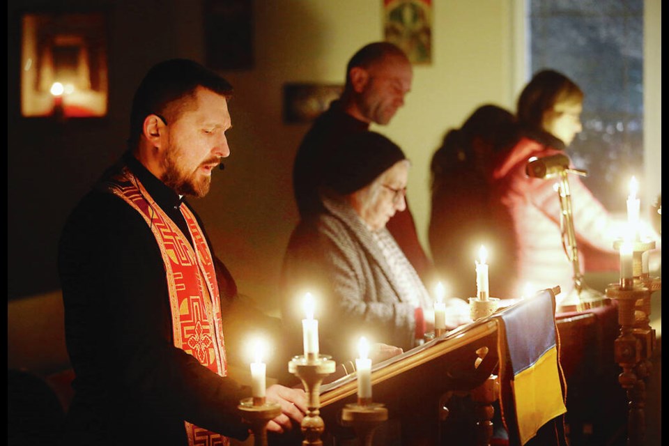 Father Yuriy Vyshnevskyy leads a Lenten service at the Ukrainian Catholic Church of St. Nicholas the ­Wonderworker on Feb. 23, 2023, one year after the Russian invasion of Ukraine. “You’re ­trying to find the right words, when all you really need is to be there, to listen,” he said of welcoming new parishoners arriving from the war-torn country. ADRIAN LAM, TIMES COLONIST 