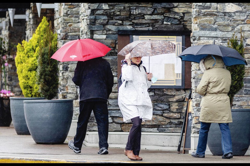 Pedestrians with umbrellas on Beacon Avenue in Sidney on Monday. DARREN STONE, TIMES COLONIST 