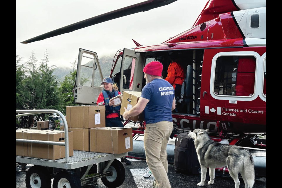 Lighthouse keeper Spence Wilson unloads a month’s worth of supplies under the watchful eye of his dog, Luke, at Boat Bluff, a light station on the central coast about 600 kilometres north of Victoria. He says keepers have to plan for four weeks or longer instead of the one or two for most people. CANADIAN COAST GUARD 