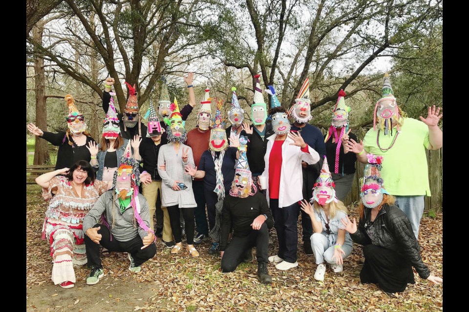 Some of the Cajun country Mardis Gras mask making participants show off their finished capuchons. The author is seen with her “dog” inspired cap on the back left. KIM PEMBERTON 