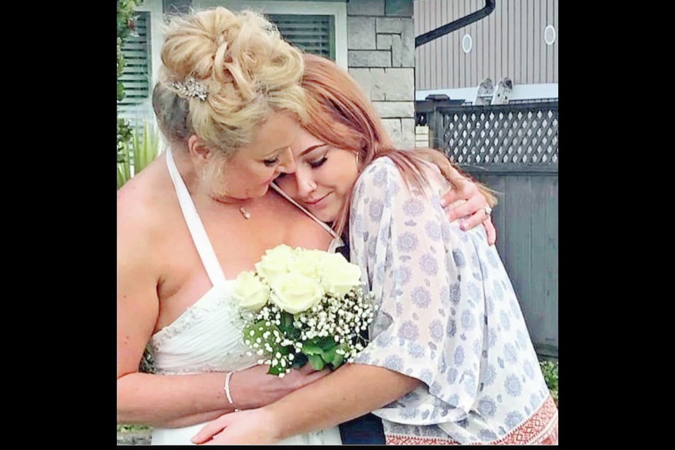 Tracy Sims on her wedding day in 2019. This is her favourite photo with Samantha, then 16. “Happiest I had ever been and Sam was so happy for us,” says Sims. “I feel her hugging me.” VIA TRACY SIMS 
