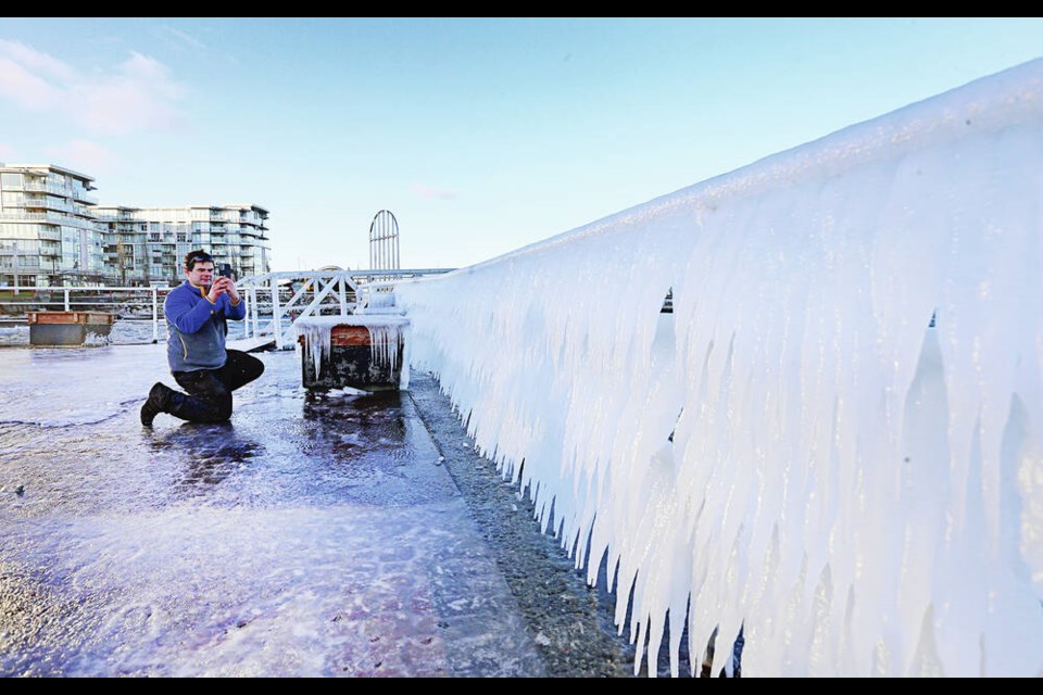 Greg Marsh takes photos of icicles on the waterfront in Sidney. ADRIAN LAM, TIMES COLONIST 