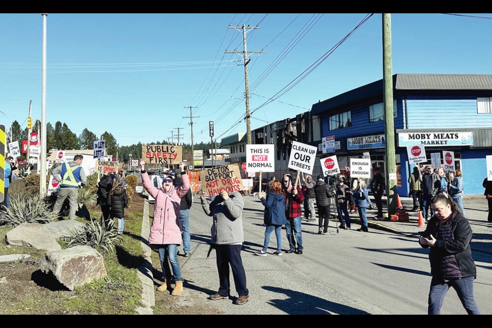 Residents rally in front of Good Neighbours thrift store on York Street in North Cowichan on Friday. A fire at the store on Feb. 10 is the subject of an arson investigation. SANDY LUKONI 