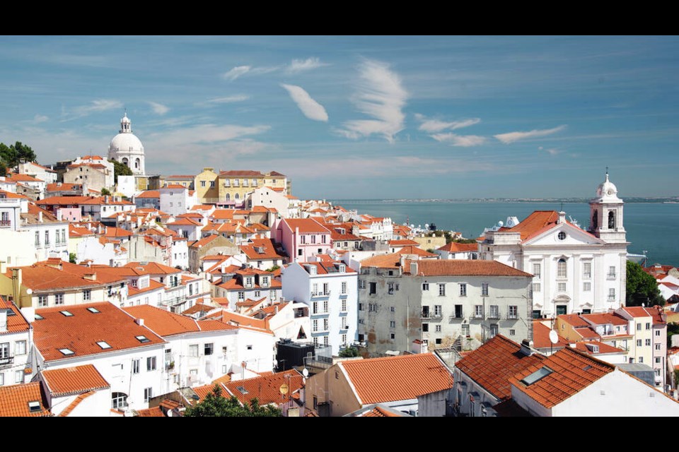 Portugal Lisbon’s hilly Alfama district is a jumble of whitewashed houses overlooking the yawning mouth of the Tejo River. CAMERON HEWITT  