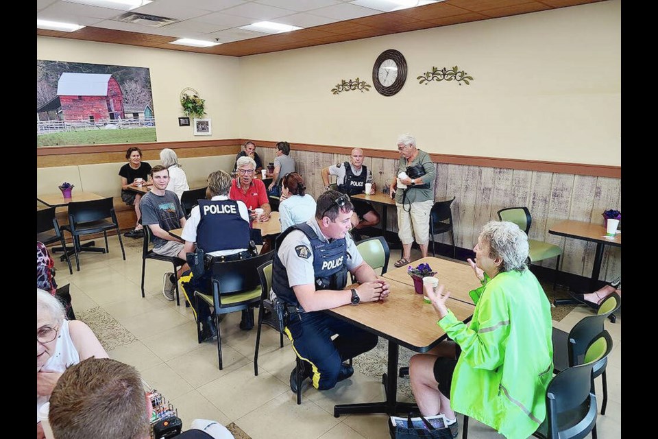 Nanaimo RCMP officers meet with residents at ­Country Grocer to answer questions, hear concerns and give people an opportunity to get to know the ­people behind the badge.  VIA NANAIMO RCMP 