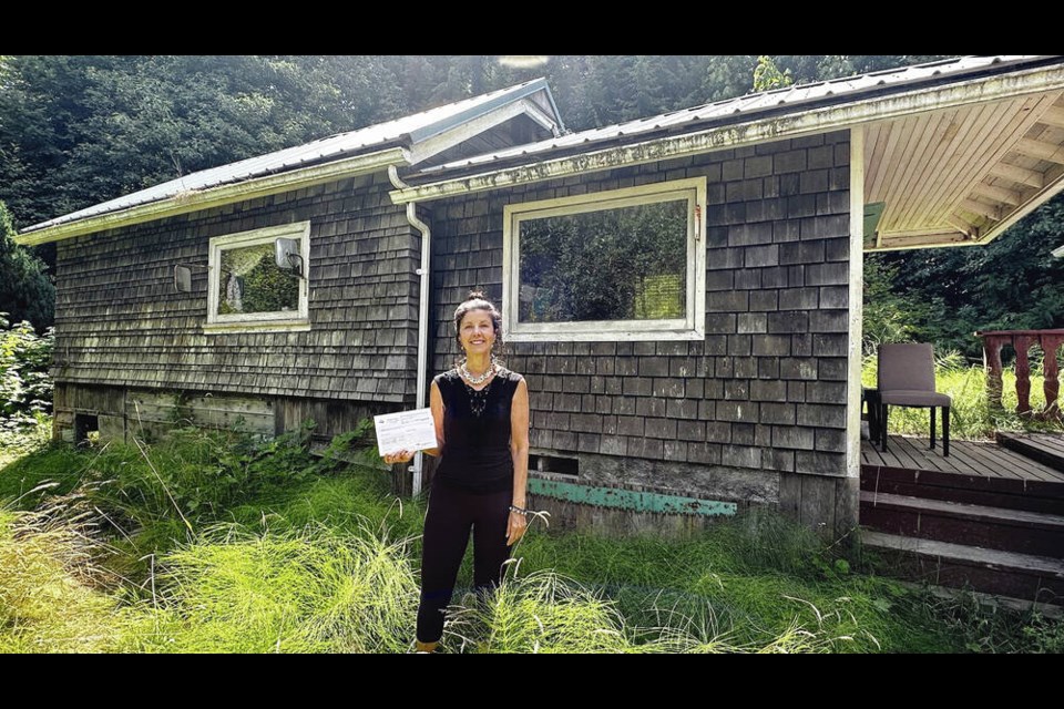 Shelly Robinson at her home in Honeymoon Bay with her assessment. VIA JASON ANSON 