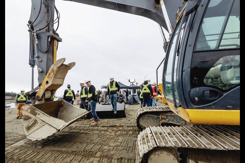 Verity Construction workers leave the podium after a groundbreaking for Beachlands, a $1.2-billion seaside ­community formerly known as Royal Beach, in Colwood on Monday. DARREN STONE, TIMES COLONIST 
