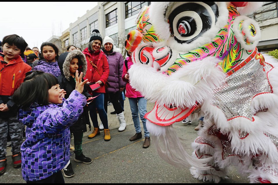 Three-year-old Ella Wu smiles and waves as the Wong Sheung Kung Fu Club performs a lion dance Saturday at Uptown to mark the Lunar New Year. This is the Year of the Dragon in the Chinese zodiac. Story and more photos, pages A4 and A5. ADRIAN LAM, TIMES COLONIST  