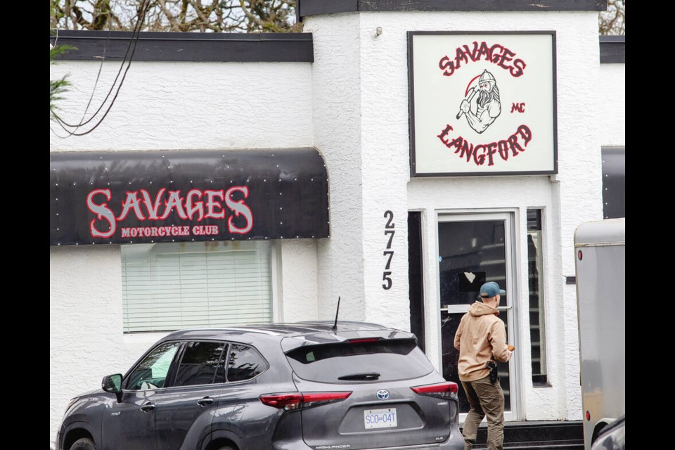A plainclothes officer outside Savages Motorcycle Club on Spencer Road in Langford during the execution of a search warrant related to a drug-trafficking investigation. DARREN STONE, TIMES COLONIST 