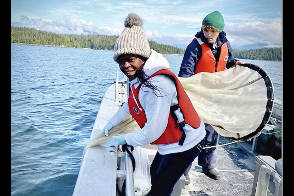 Researcher Oladimeji Ayo Iwalaye, front, collects marine life for microplastics research. VIA OCEAN WISE 
