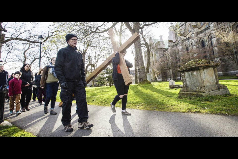 Parishioners and guests from Christ Church Cathedral walk through Pioneer Park during the Good Friday Passion Procession in 2018. DARREN STONE, TIMES COLONIST 